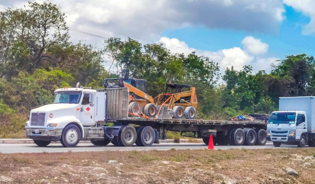 Flatbed vs wheel lift towing comparison showing two different tow truck methods