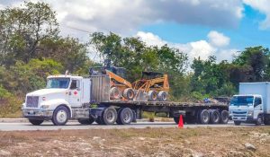 Flatbed vs wheel lift towing comparison showing two different tow truck methods