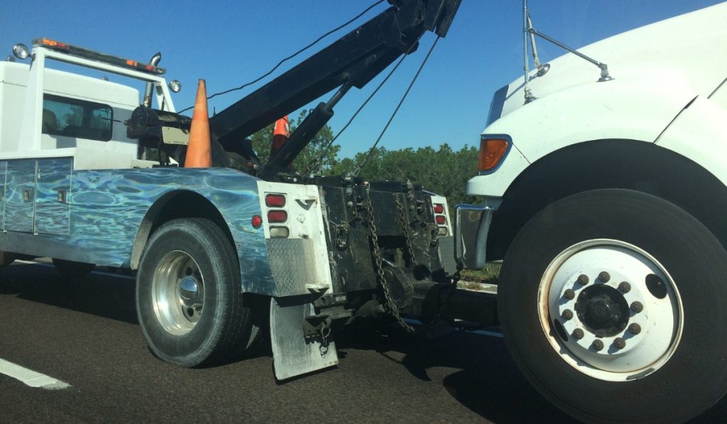 Tow truck winching a car from a ditch in Fort Collins