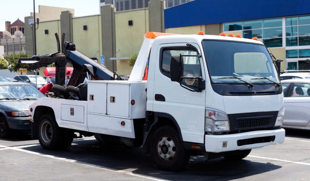 Different types of tow trucks including flatbed and wheel lift