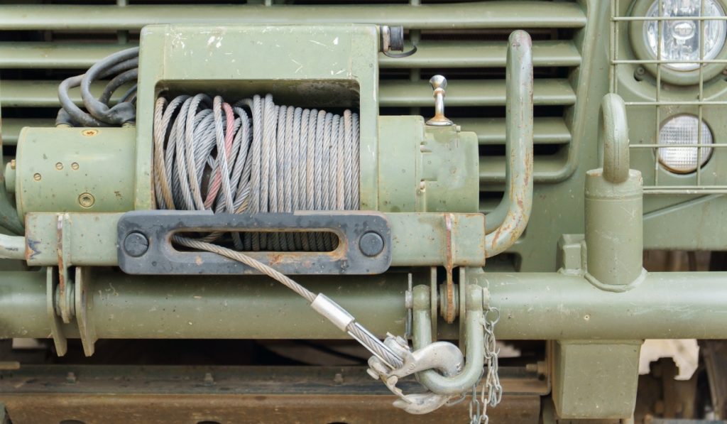 Tow truck winching a stuck car out of a ditch